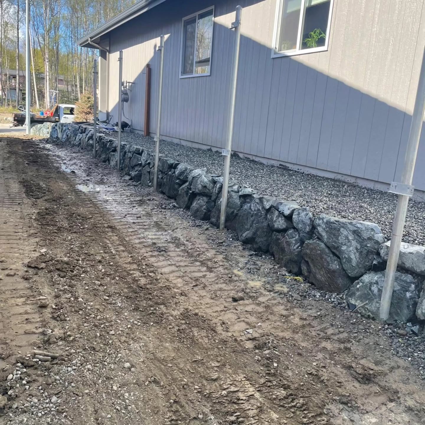 Finished natural stone retaining wall with gravel bed — Blackstone Landscaping AK